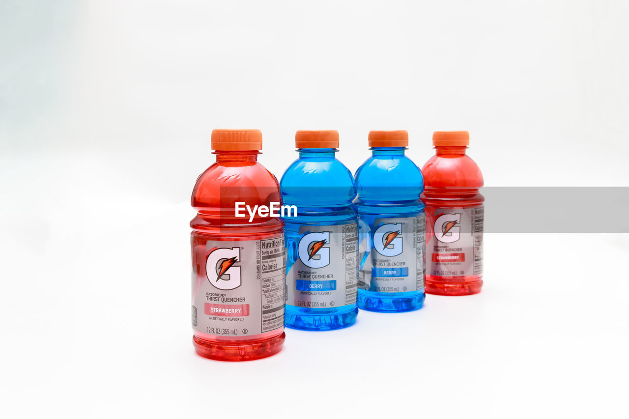 bottle, container, plastic bottle, white background, drinkware, studio shot, indoors, no people, group of objects, cut out, water, red, multi colored, healthcare and medicine, soft drink, in a row, variation, plastic, glass bottle, large group of objects, food, drink, copy space, medicine