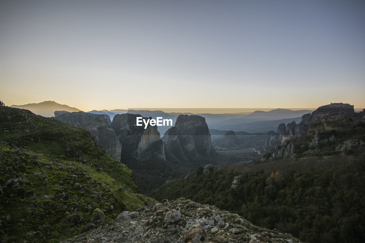 Scenic view of landscape against clear sky during sunset