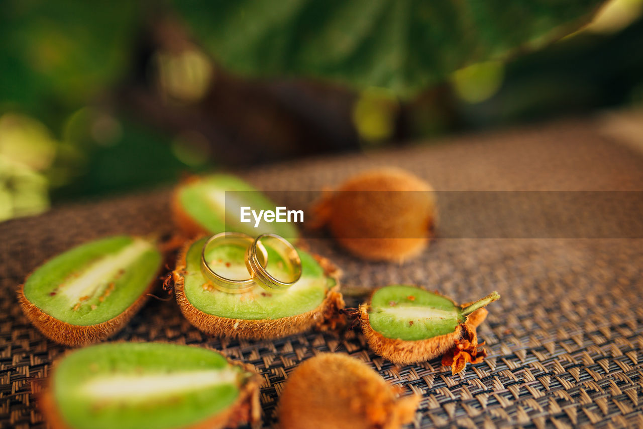 CLOSE-UP OF GREEN FRUITS ON TABLE