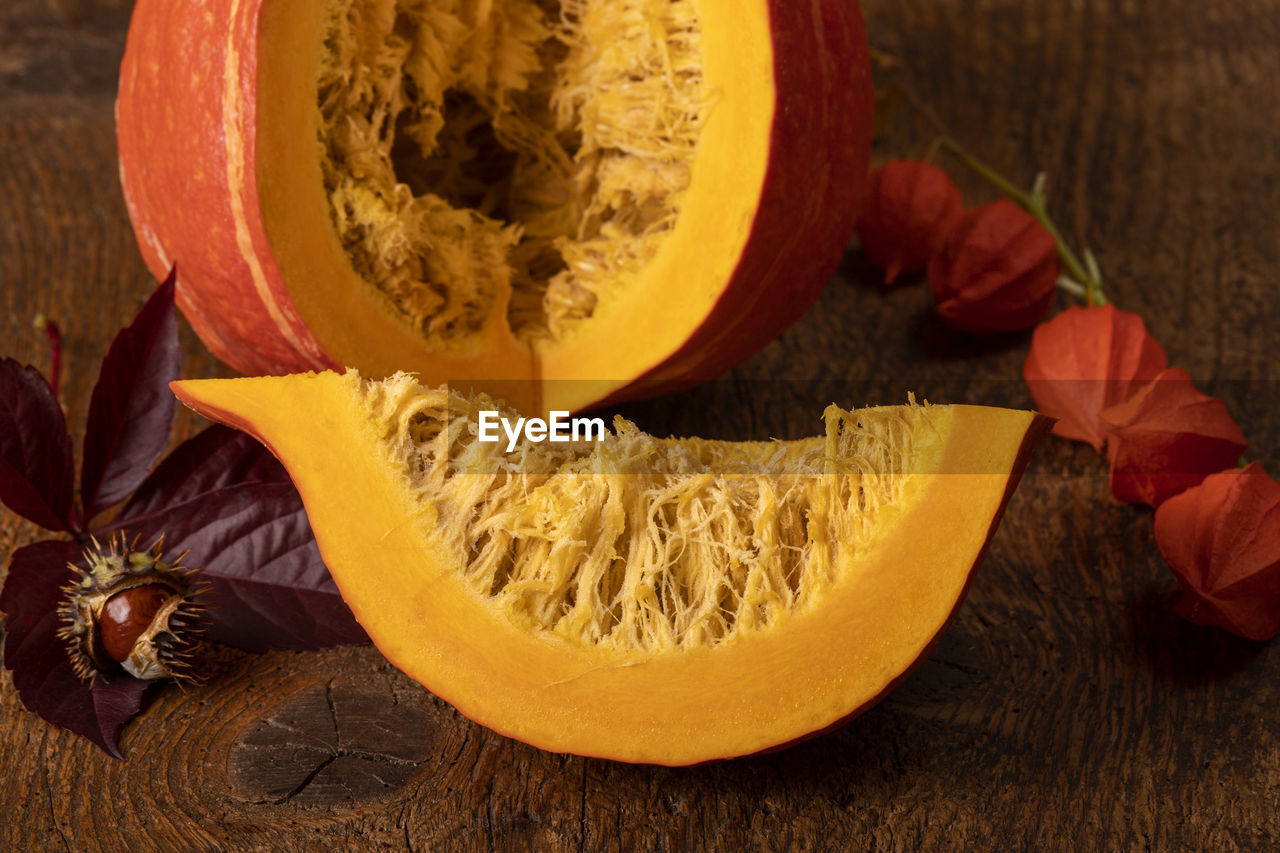 HIGH ANGLE VIEW OF ORANGE SLICE ON TABLE AT HOME