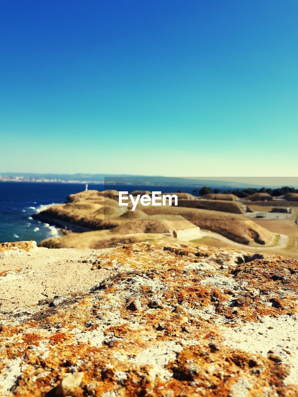 VIEW OF BEACH AGAINST CLEAR BLUE SKY