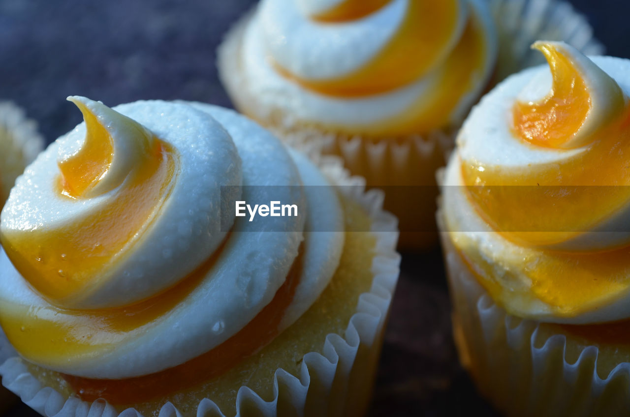Close-up of mango puree on cupcakes
