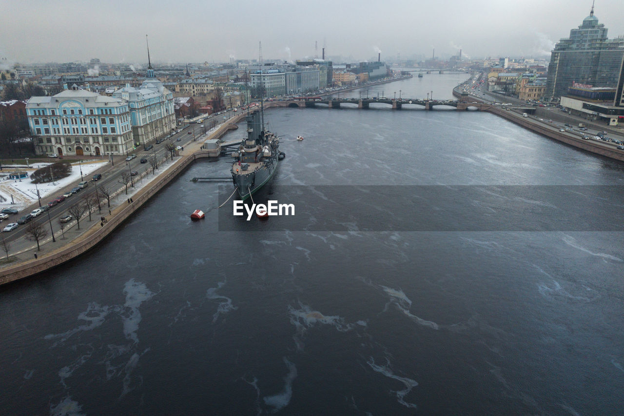 High angle view of ship moored on river amidst buildings in city