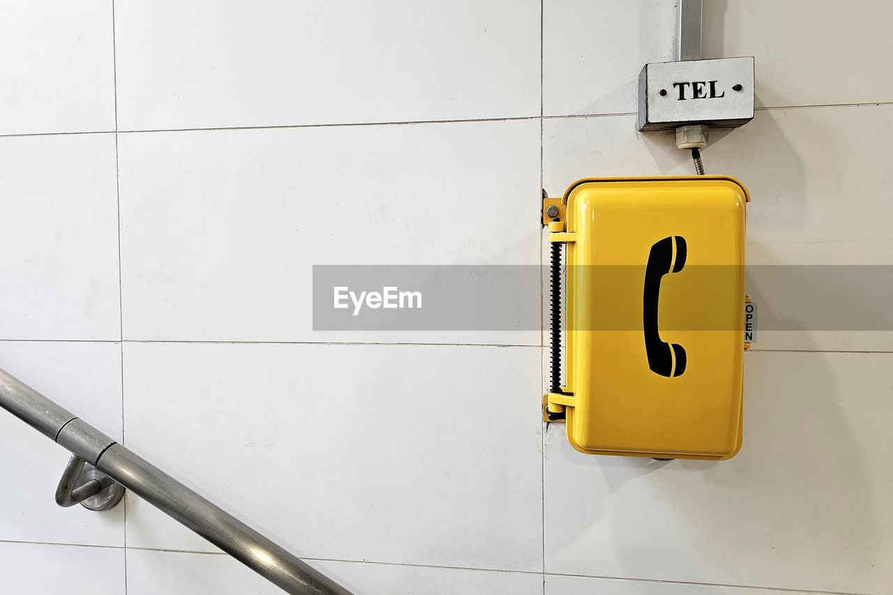 tile, bathroom, public building, sign, public restroom, communication, yellow, indoors, flooring, wall - building feature, no people, plumbing fixture, restroom sign, domestic room, tiled floor