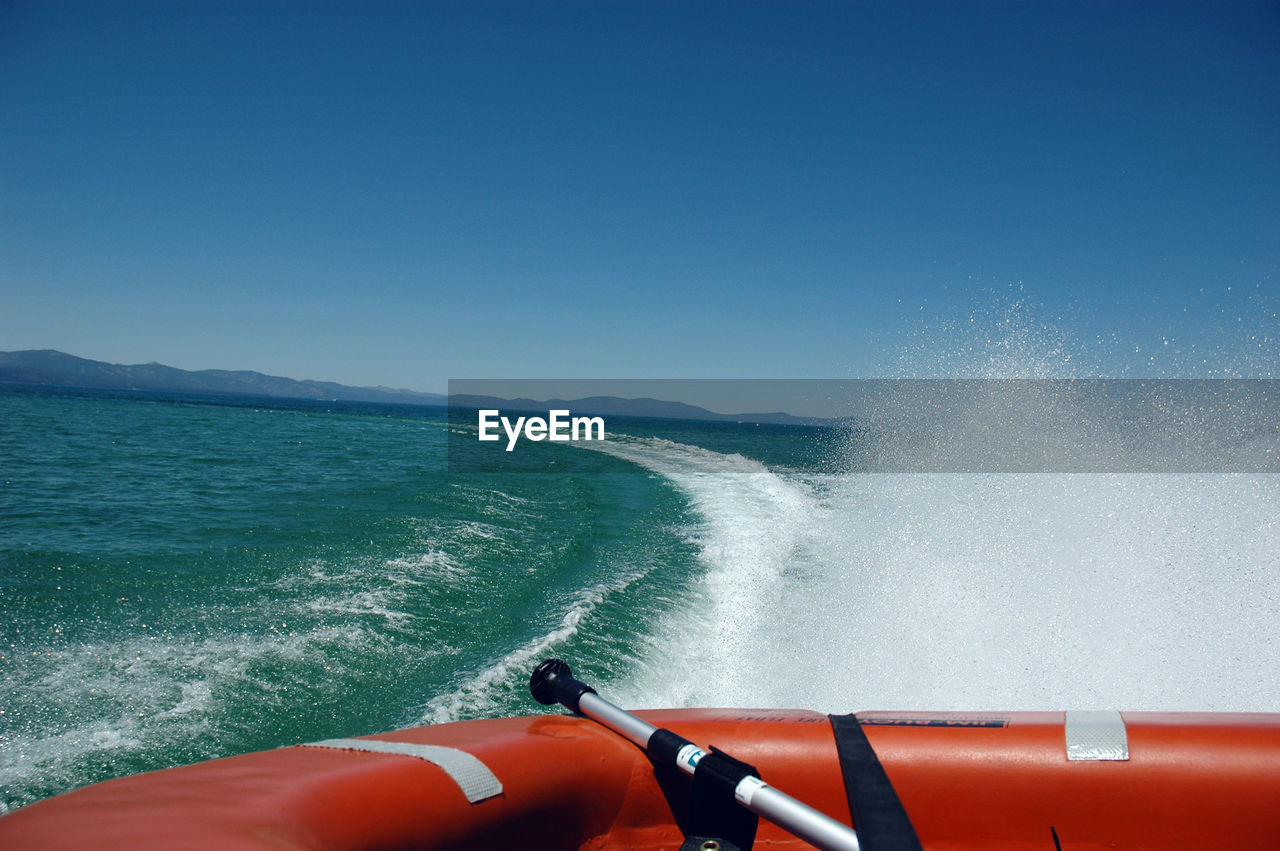 Boat moving on sea against sky