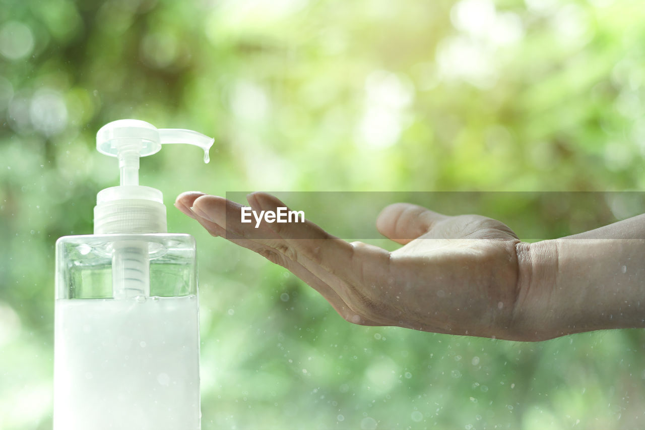 Close-up of hand using sanitizer