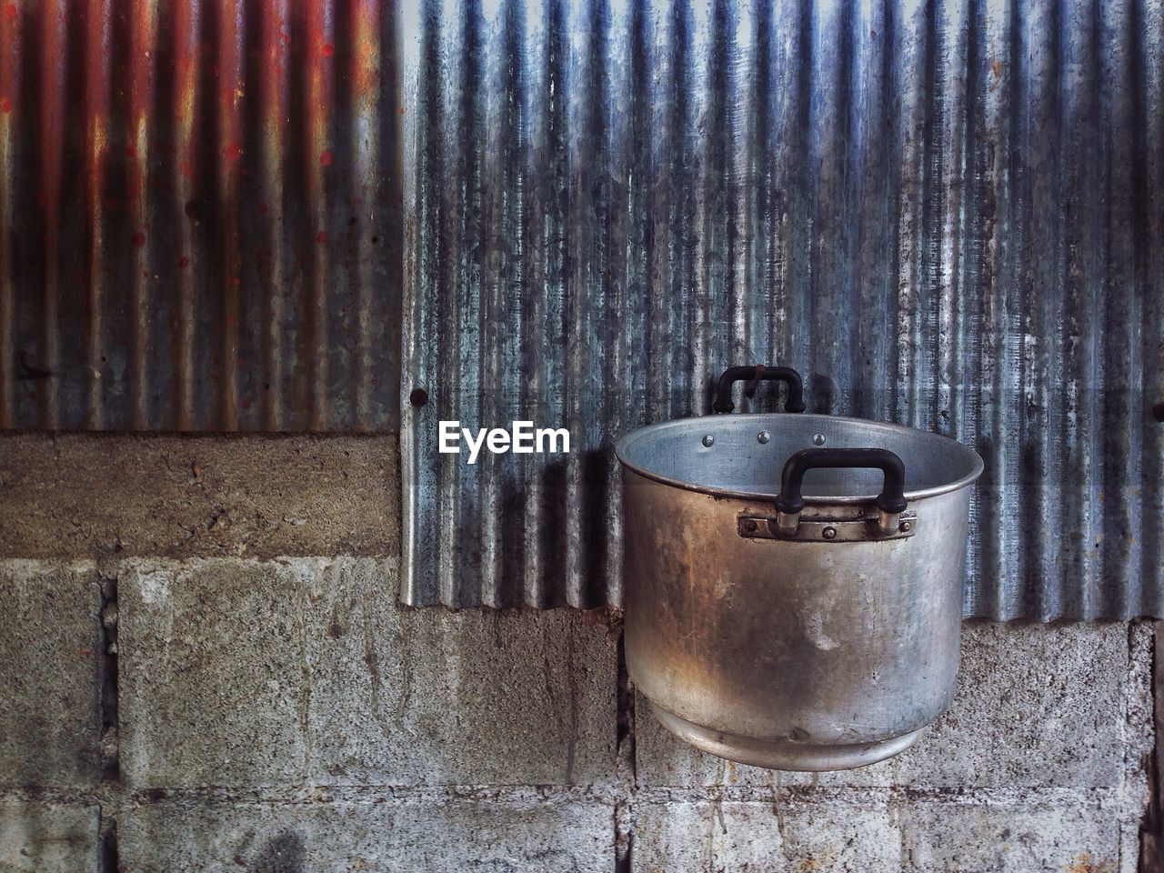 Close-up of pot hanging on wall