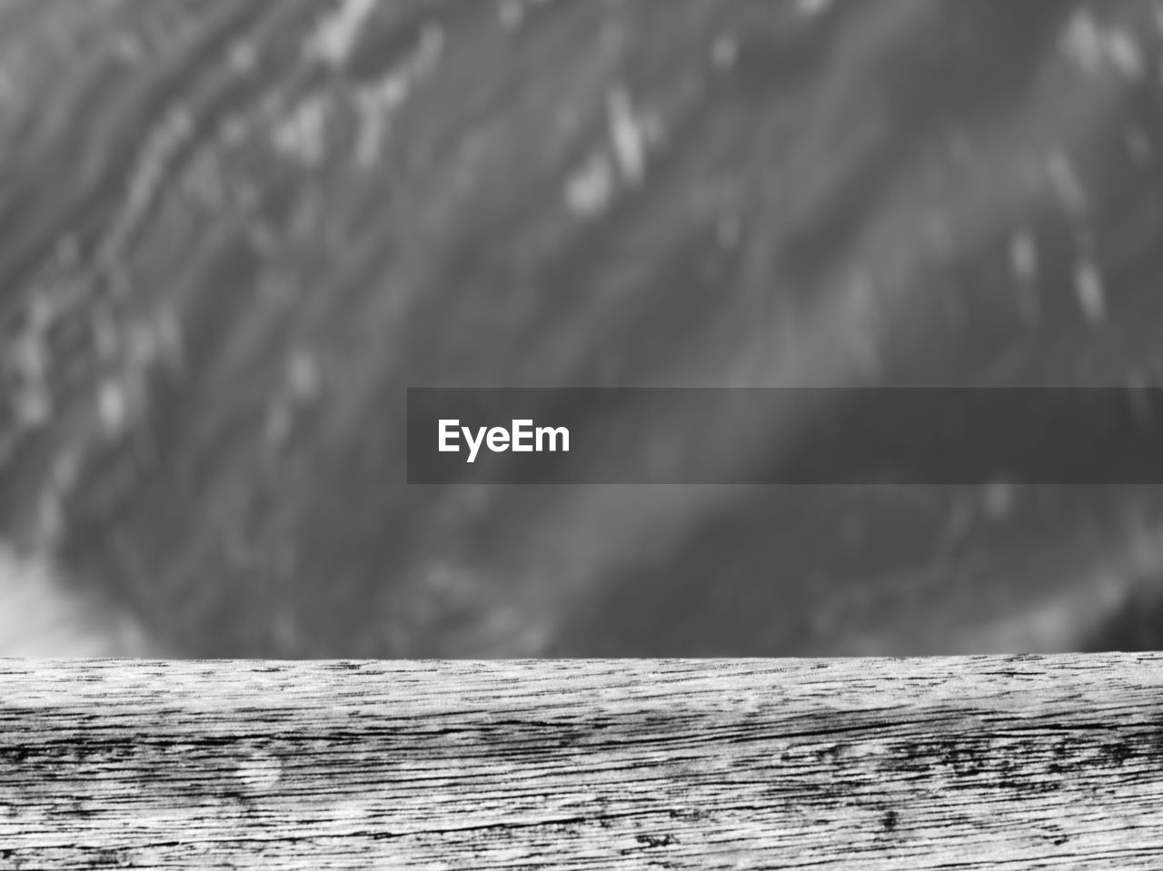 CLOSE-UP OF WOOD AGAINST SEA AND SKY