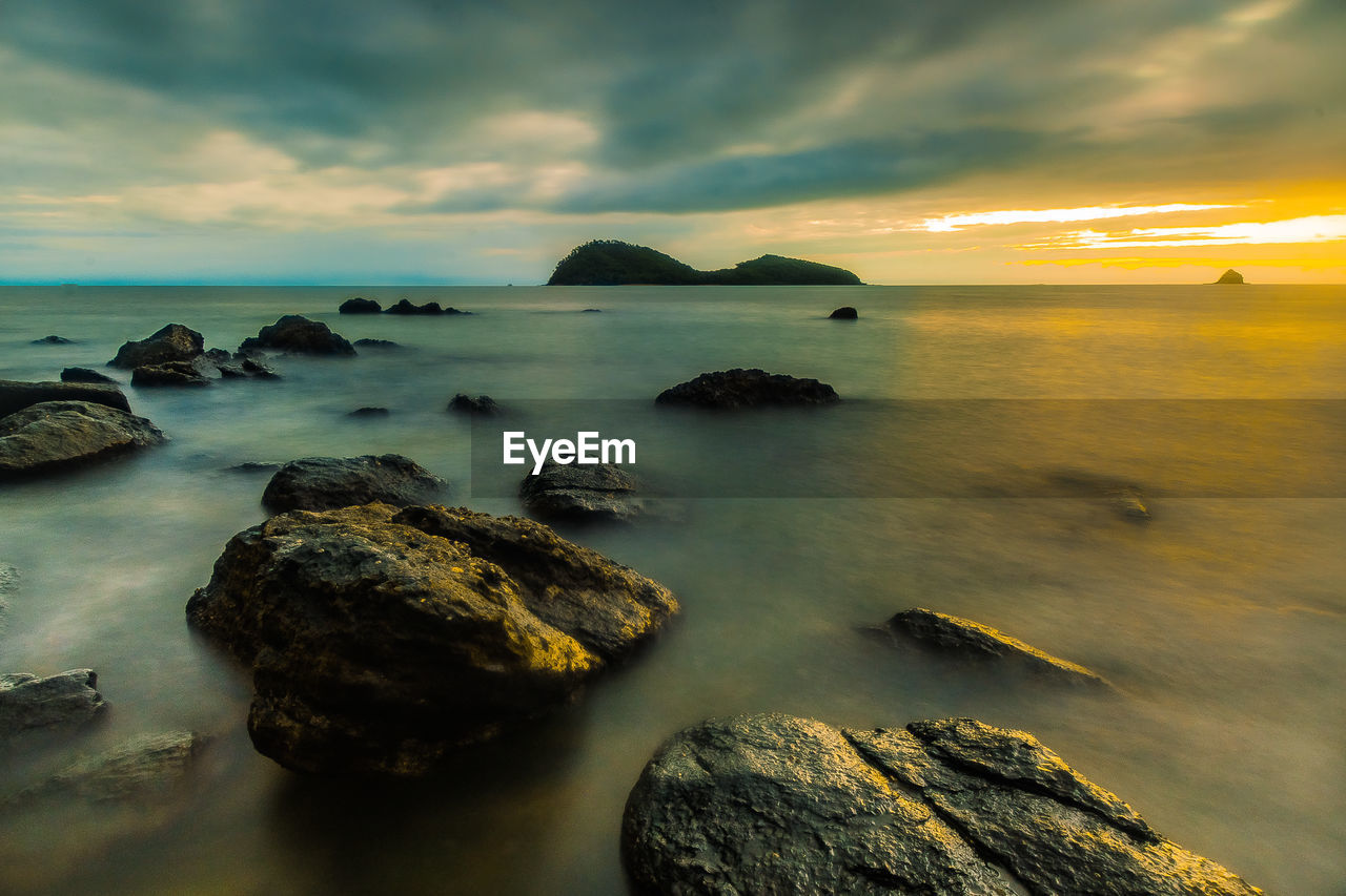 Scenic view of sea against cloudy sky