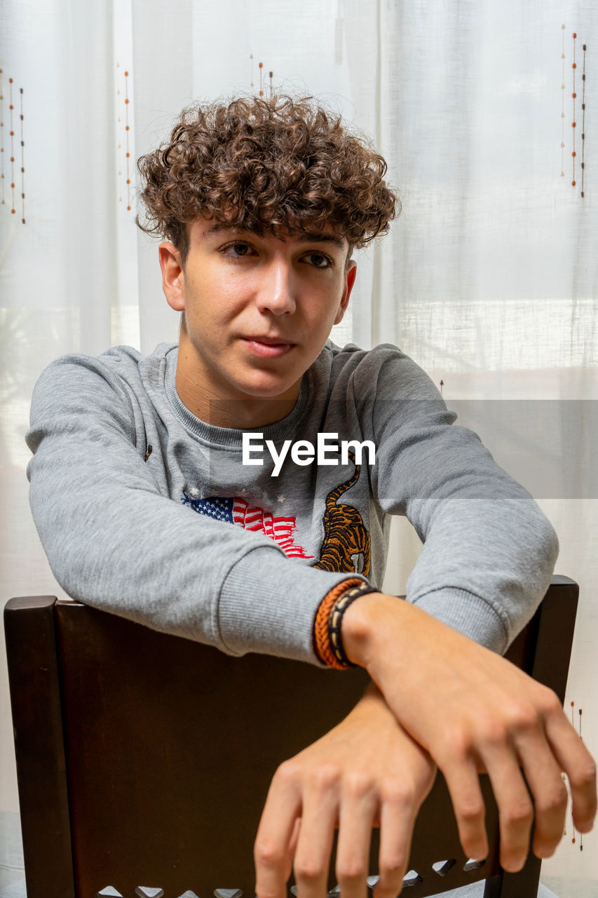 Portrait of young man sitting outdoors