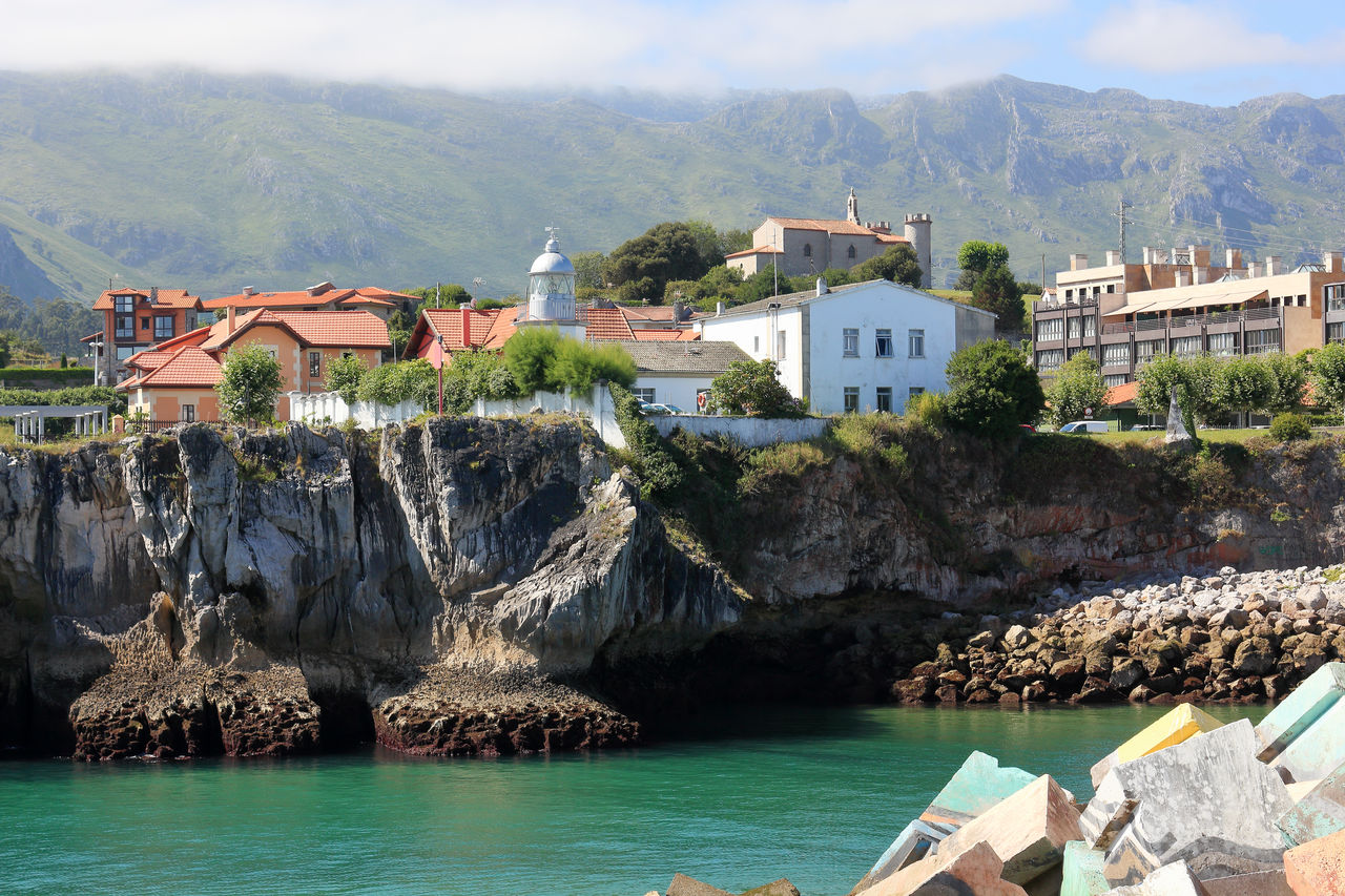 BUILDINGS BY SEA AGAINST SKY