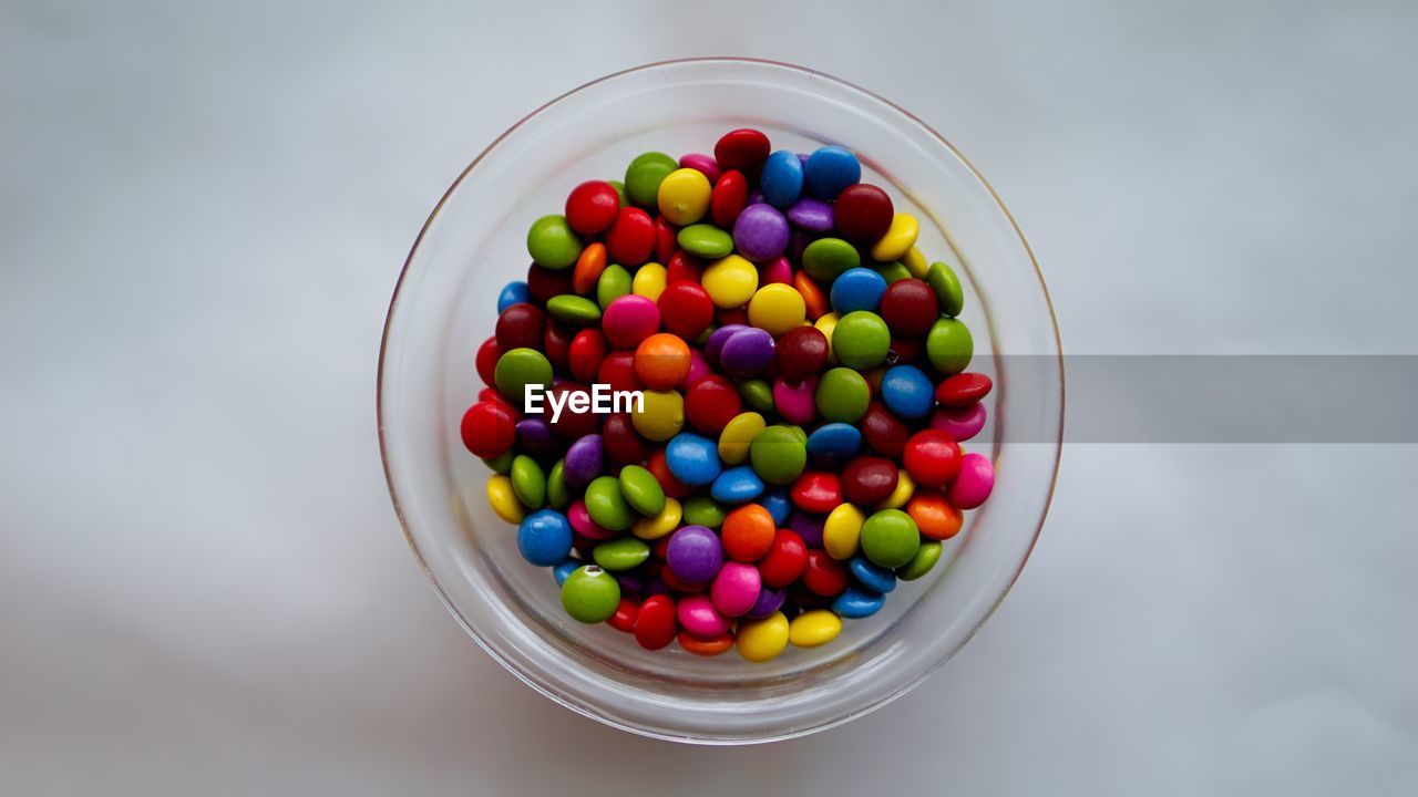 CLOSE-UP OF COLORFUL CANDIES IN CONTAINER