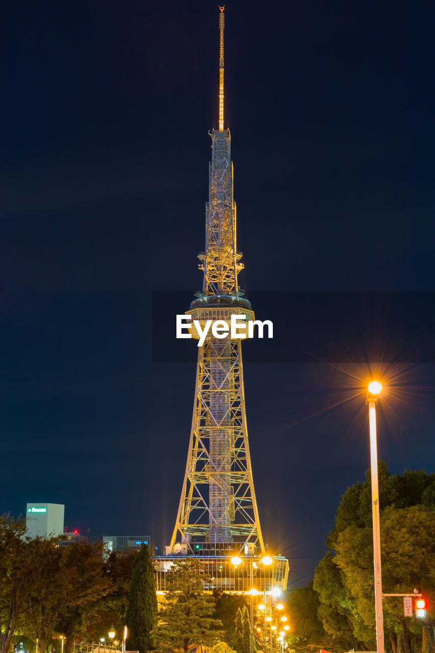 LOW ANGLE VIEW OF ILLUMINATED TOWER AGAINST SKY