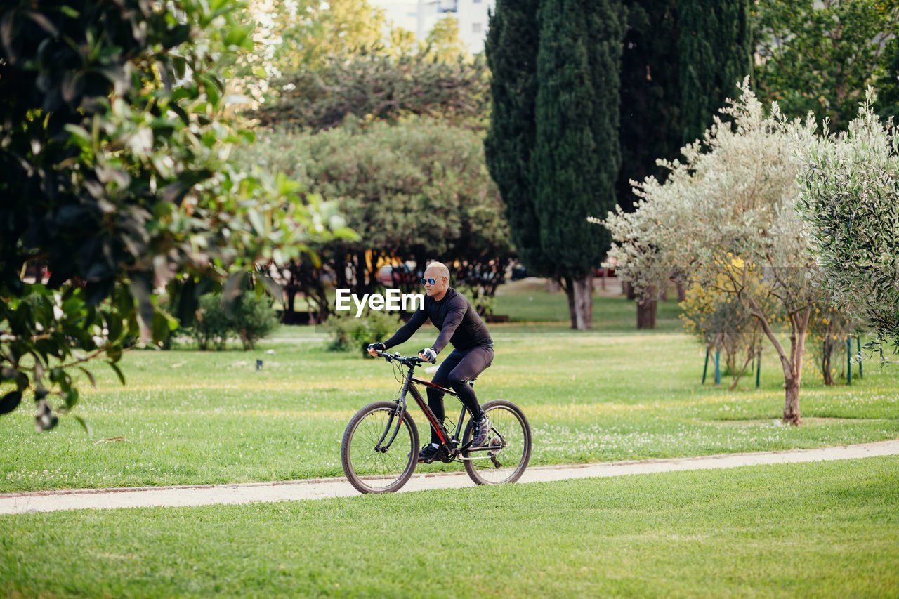 Man riding bicycle in park