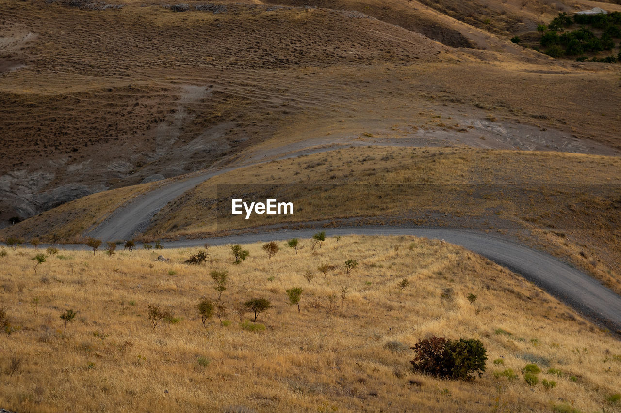 A dirt road in the steppe with hills