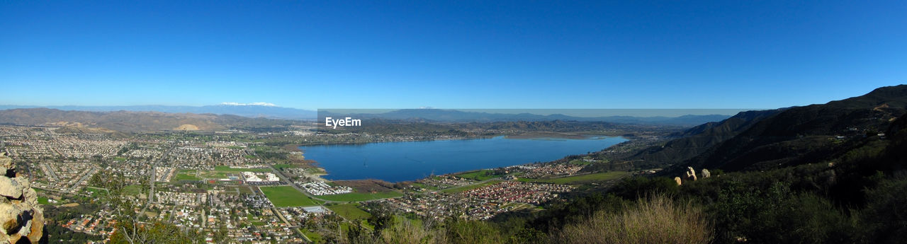 Panoramic view of landscape against blue sky