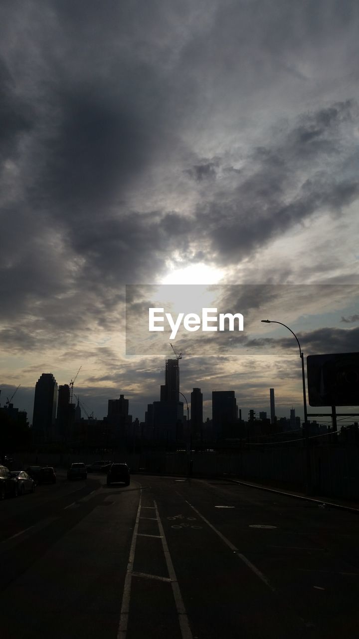 ROAD AGAINST CLOUDY SKY AT SUNSET