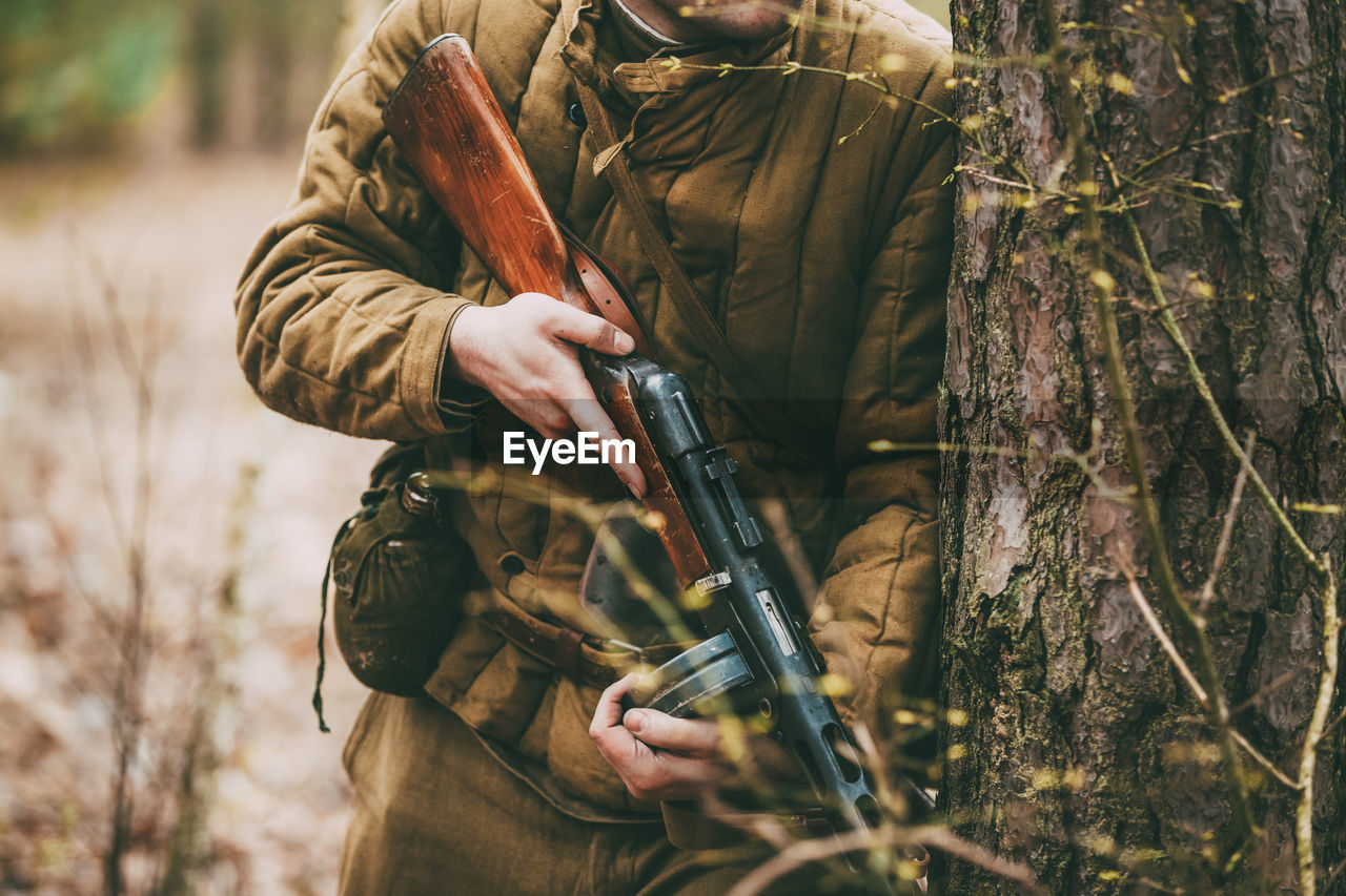 Man holding gun in forest