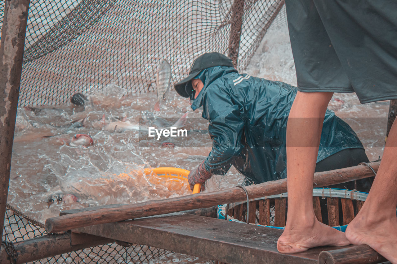 Fisherman fishing in sea