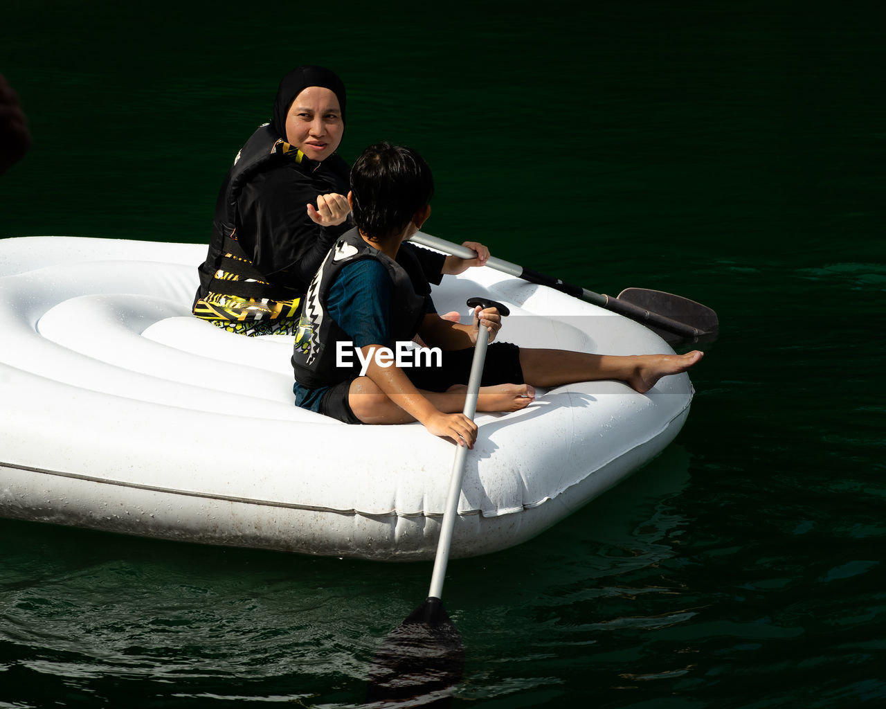 Man and woman in boat on lake