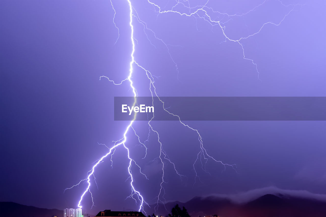 LOW ANGLE VIEW OF LIGHTNING AGAINST DRAMATIC SKY