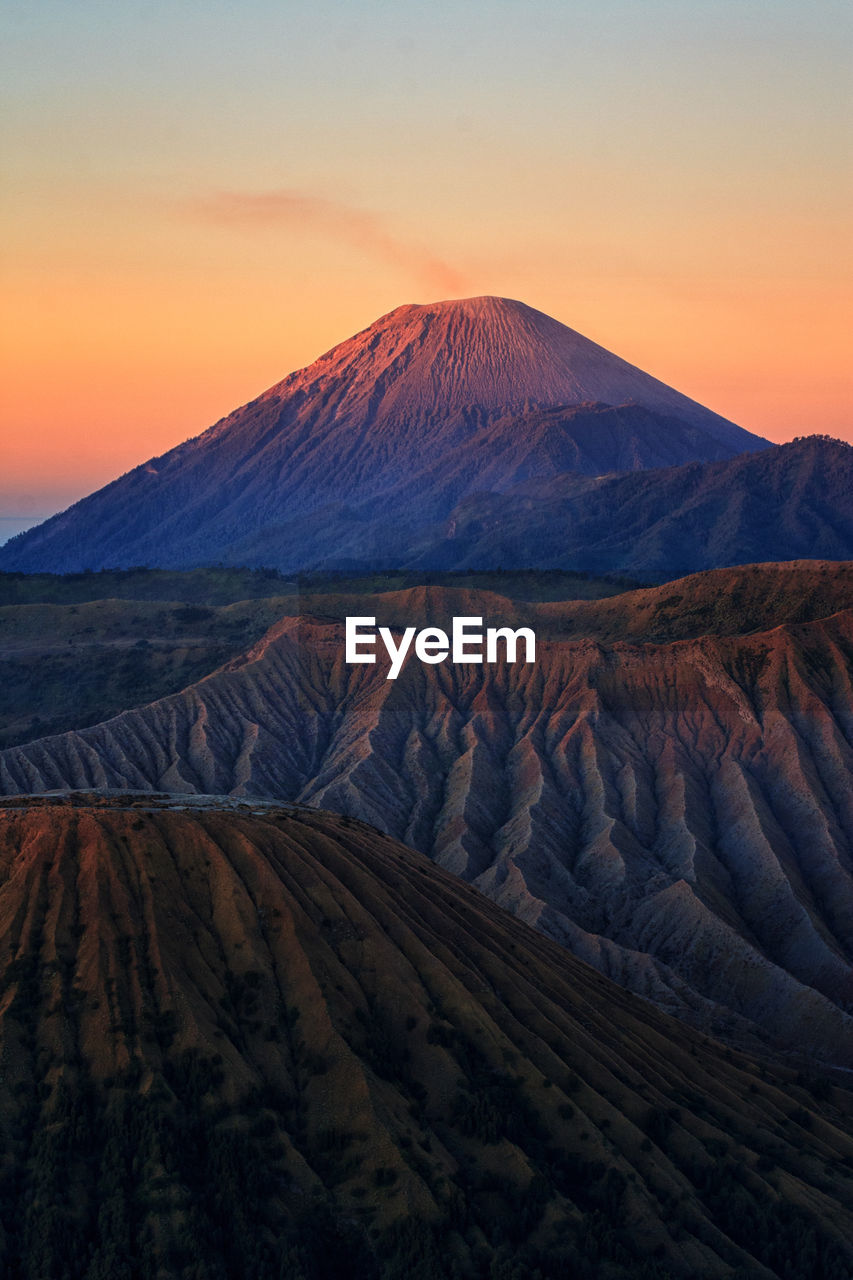 Scenic view of mountain range against sky during sunset