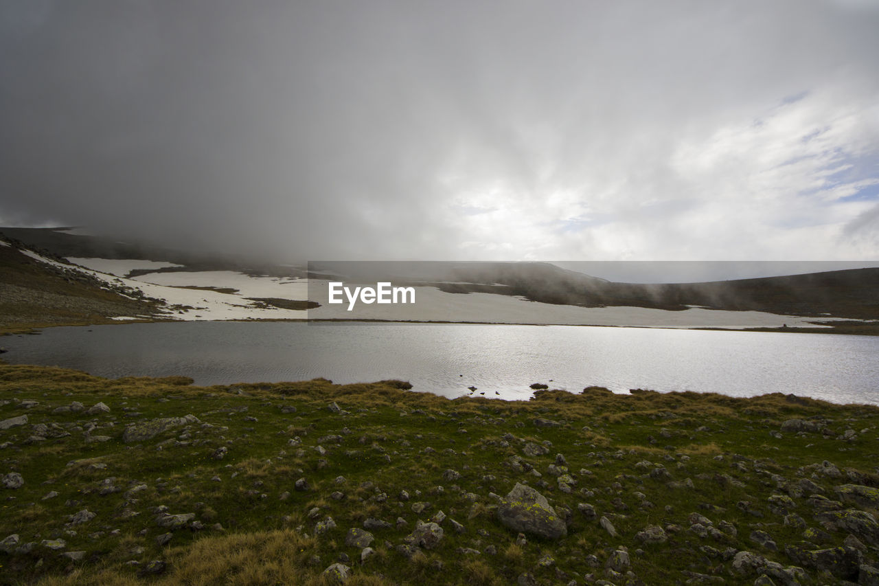 Alpine mountain lake landscape and view, snow and clouds in javakheti, georgia