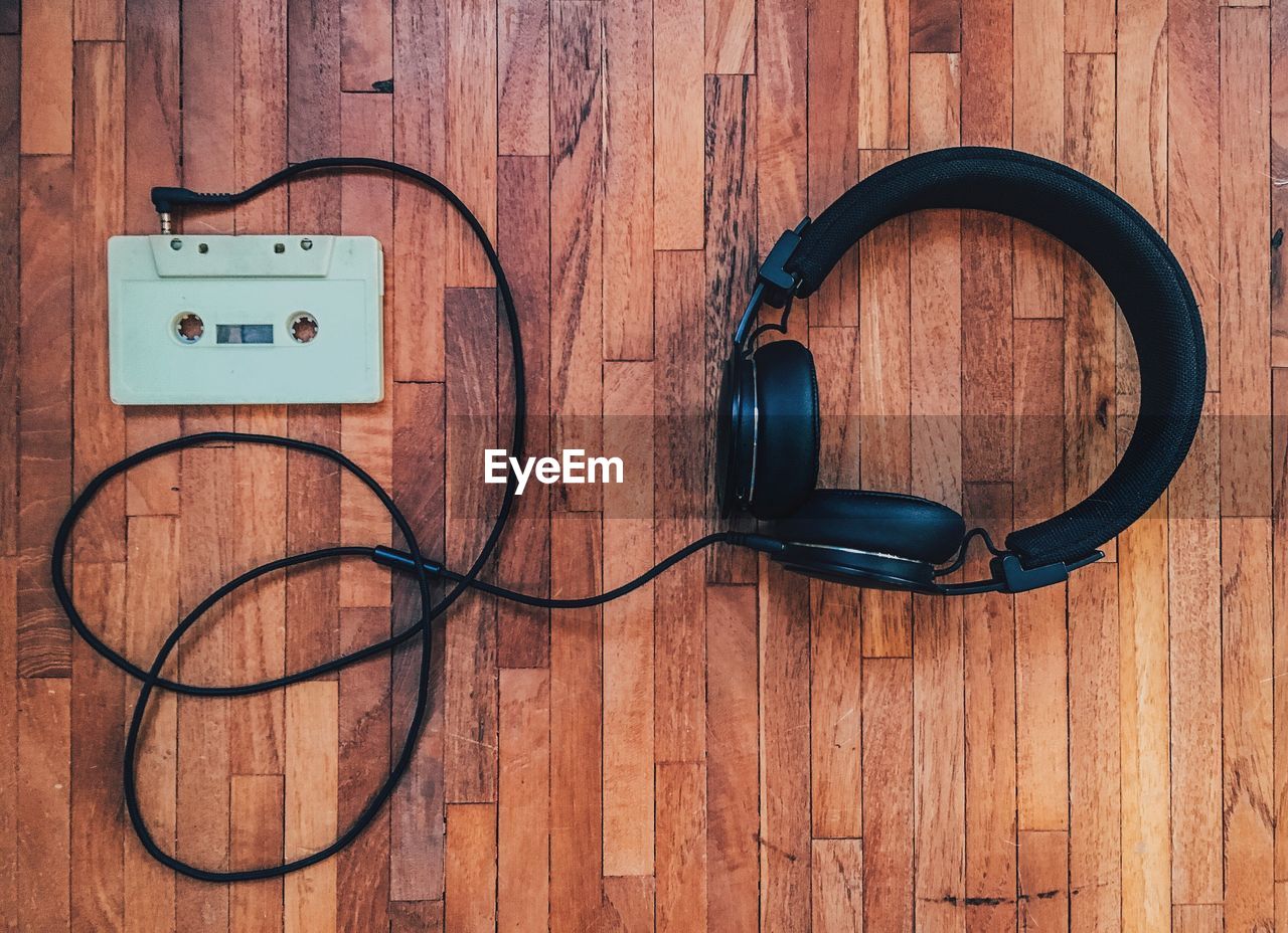 High angle view of cassette tape and headphones