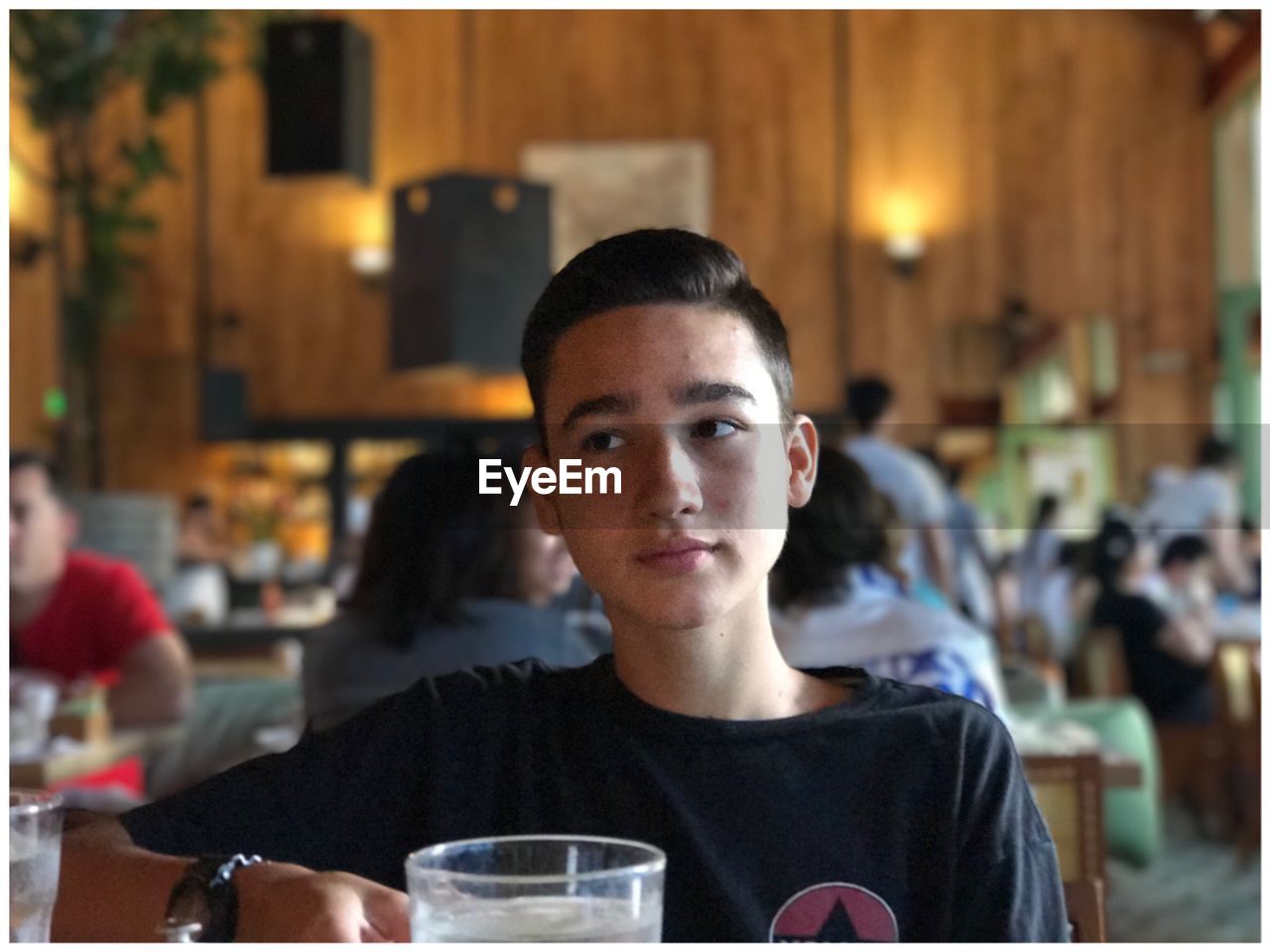 Boy looking away while sitting at restaurant