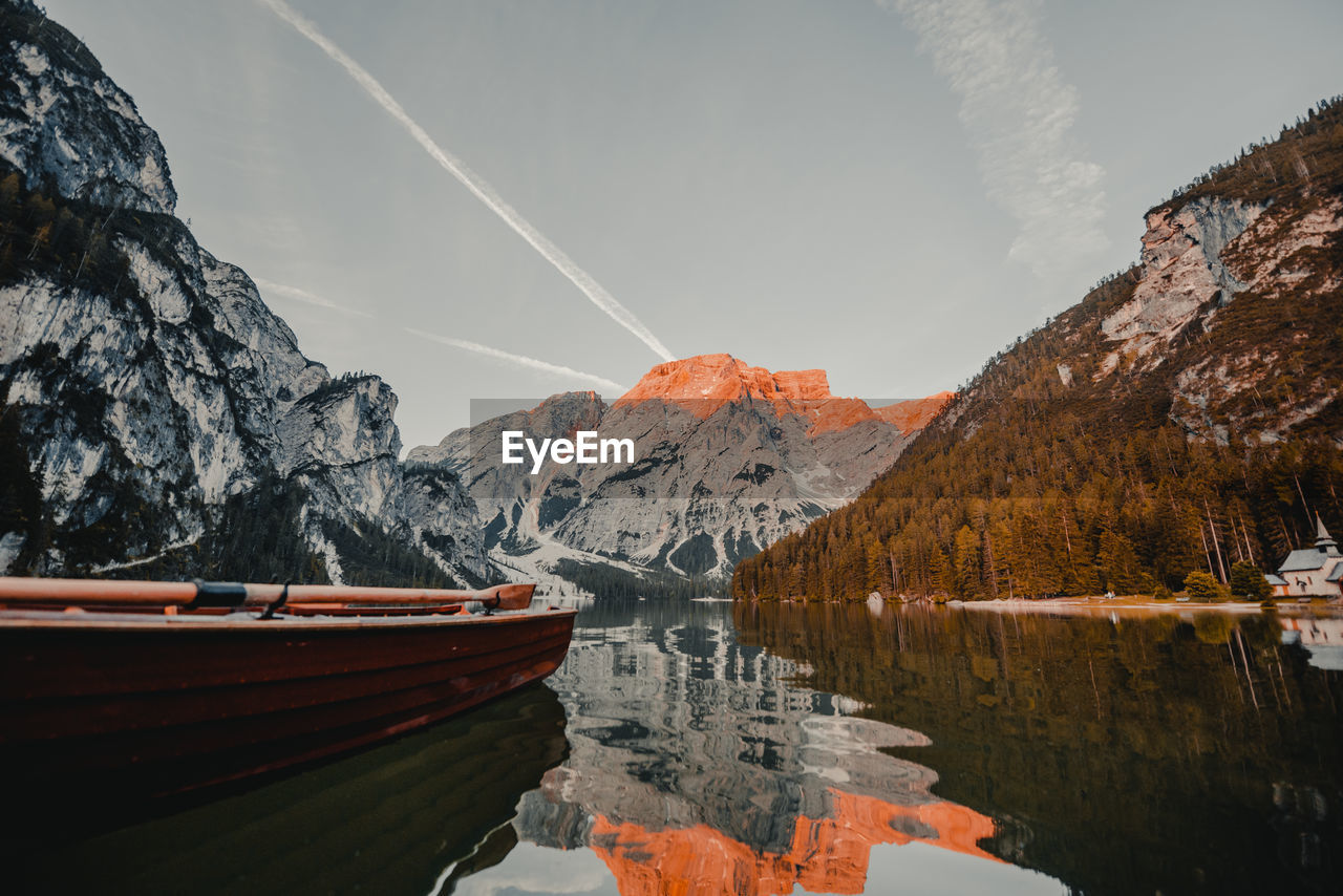 Scenic view of lake by mountains against sky