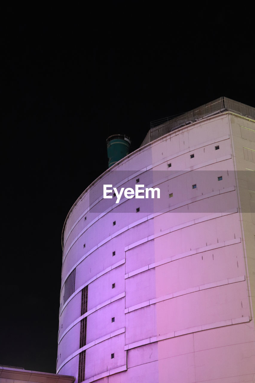 LOW ANGLE VIEW OF ILLUMINATED BUILDING AGAINST SKY