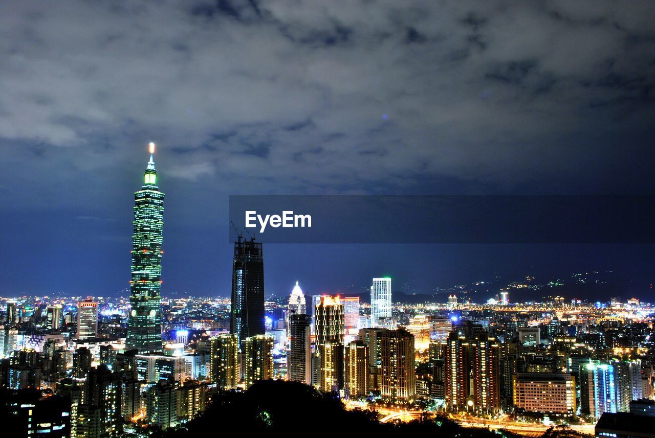 AERIAL VIEW OF ILLUMINATED BUILDINGS AGAINST SKY