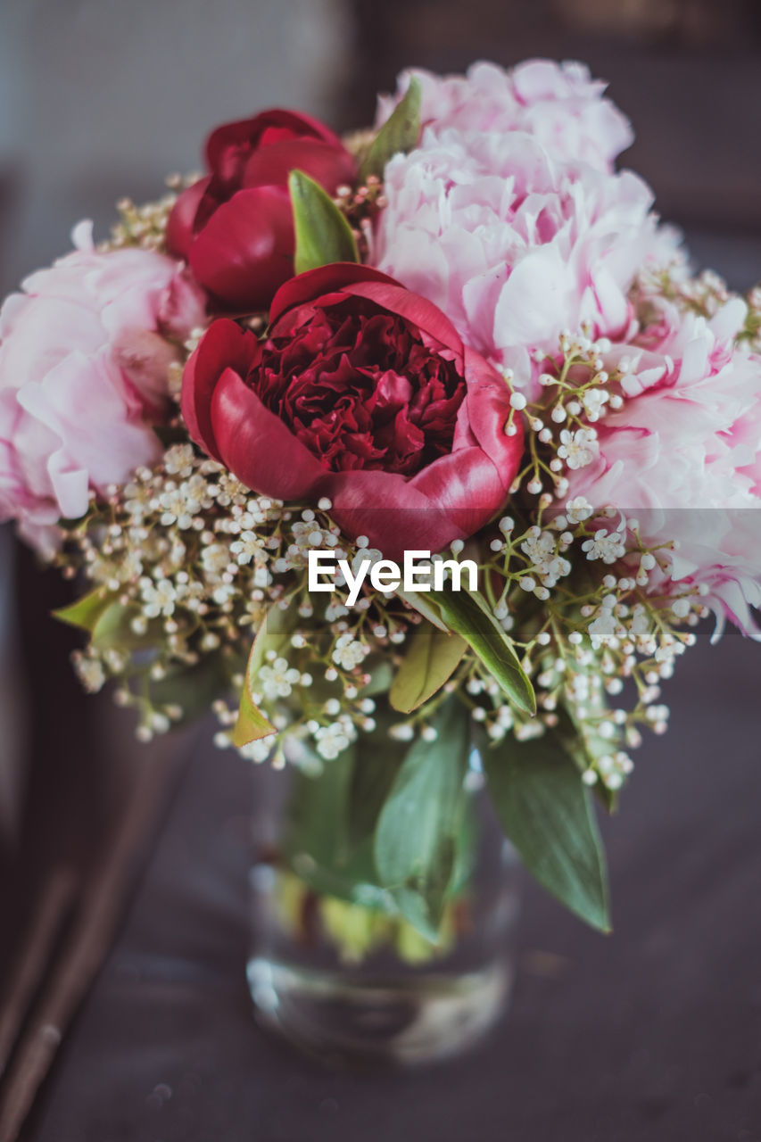 Close-up of flower arrangement with pink peonies in vase