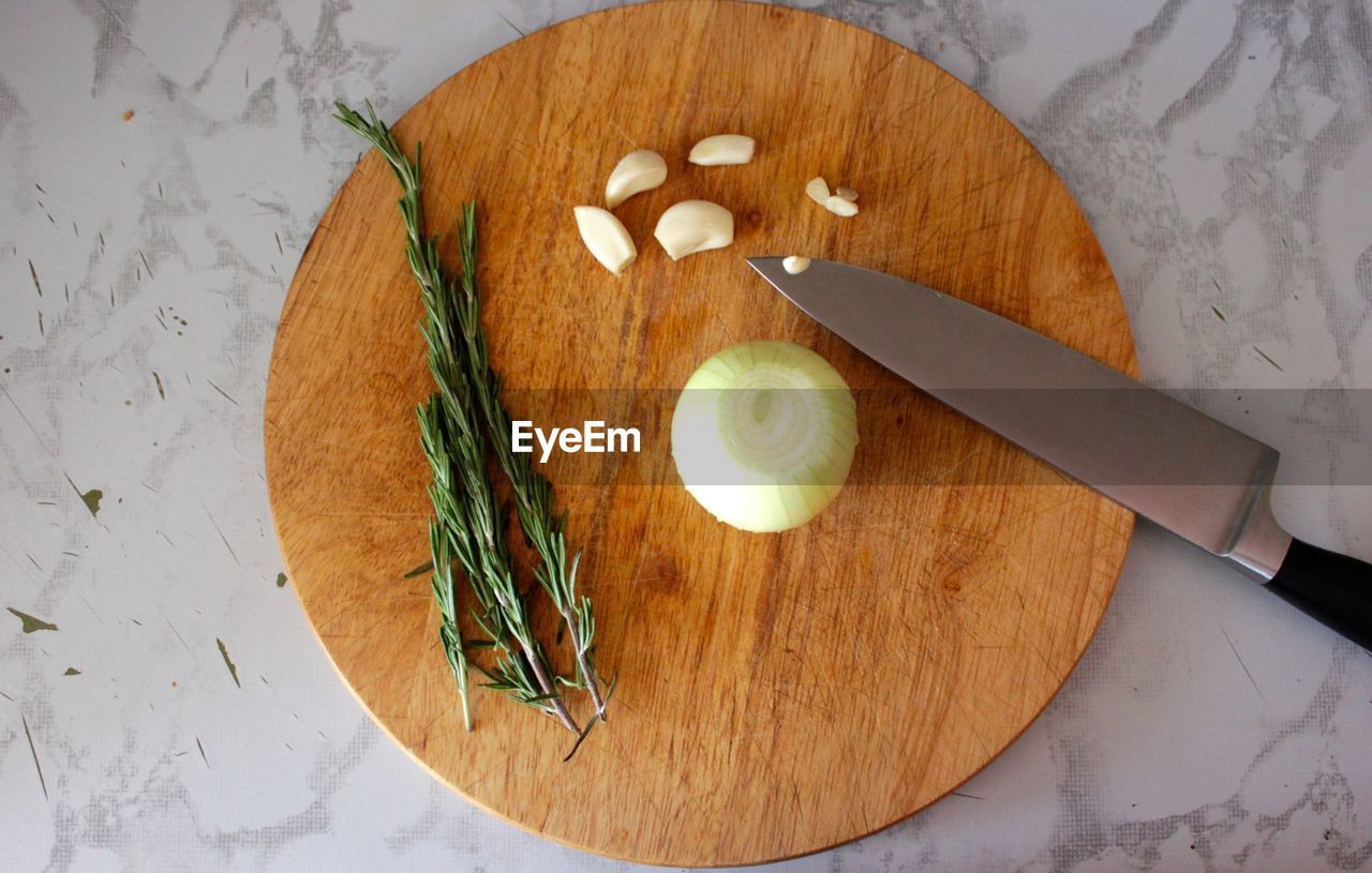 Overhead view of cutting board with kitchen knife