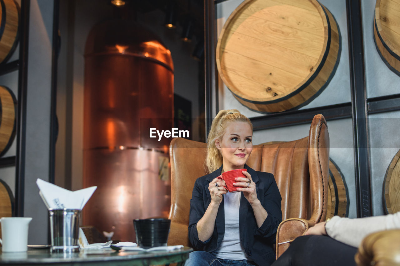 Woman listening to friend in cafe