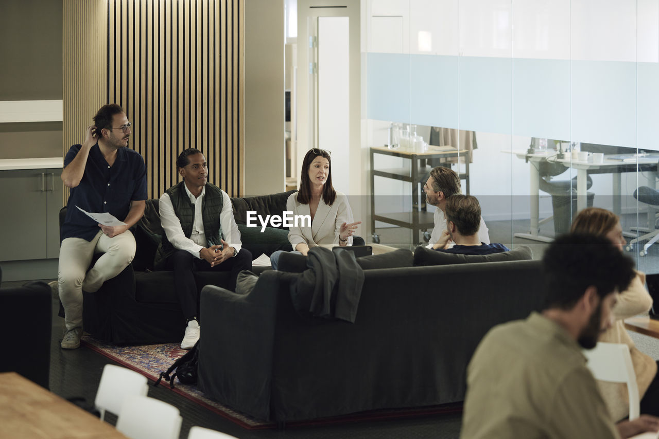 Group of business people having meeting in lobby