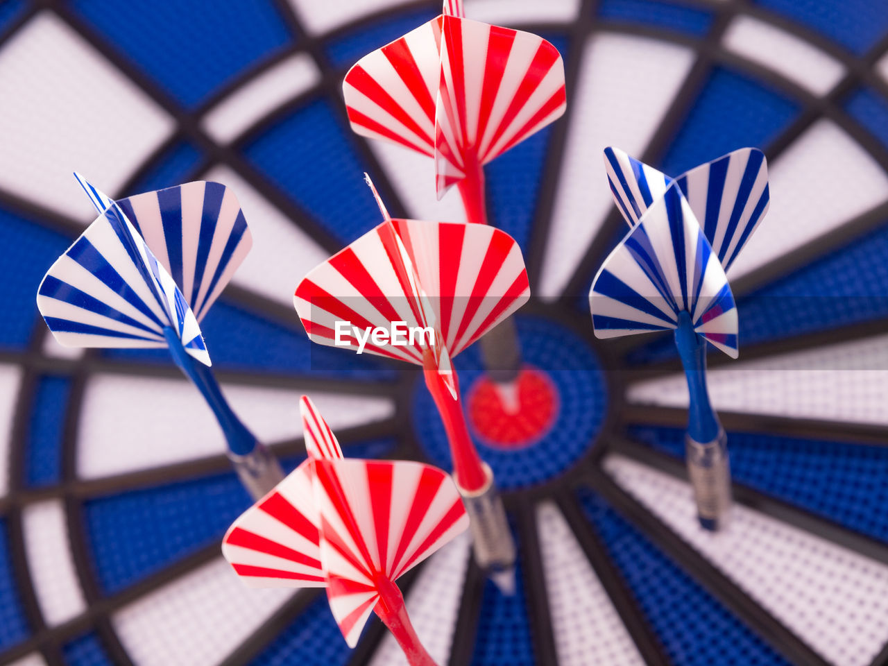 Close-up of darts on dartboard