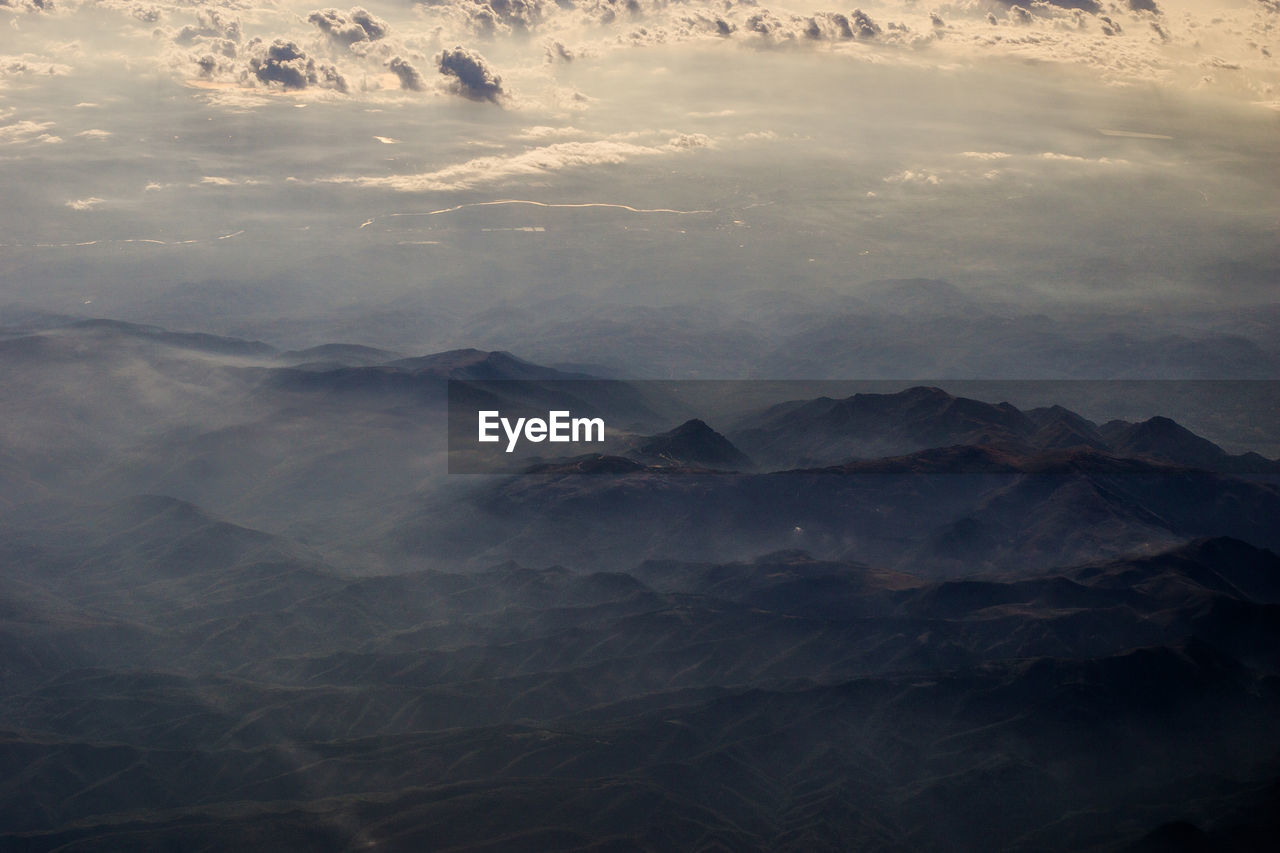 AERIAL VIEW OF VOLCANIC LANDSCAPE AGAINST SKY