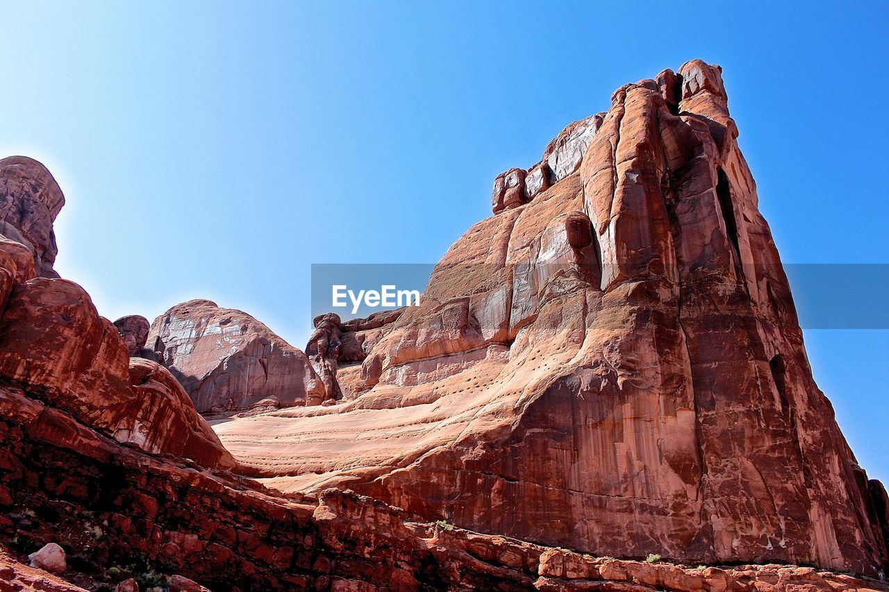 Scenic view of rocky mountains against blue sky