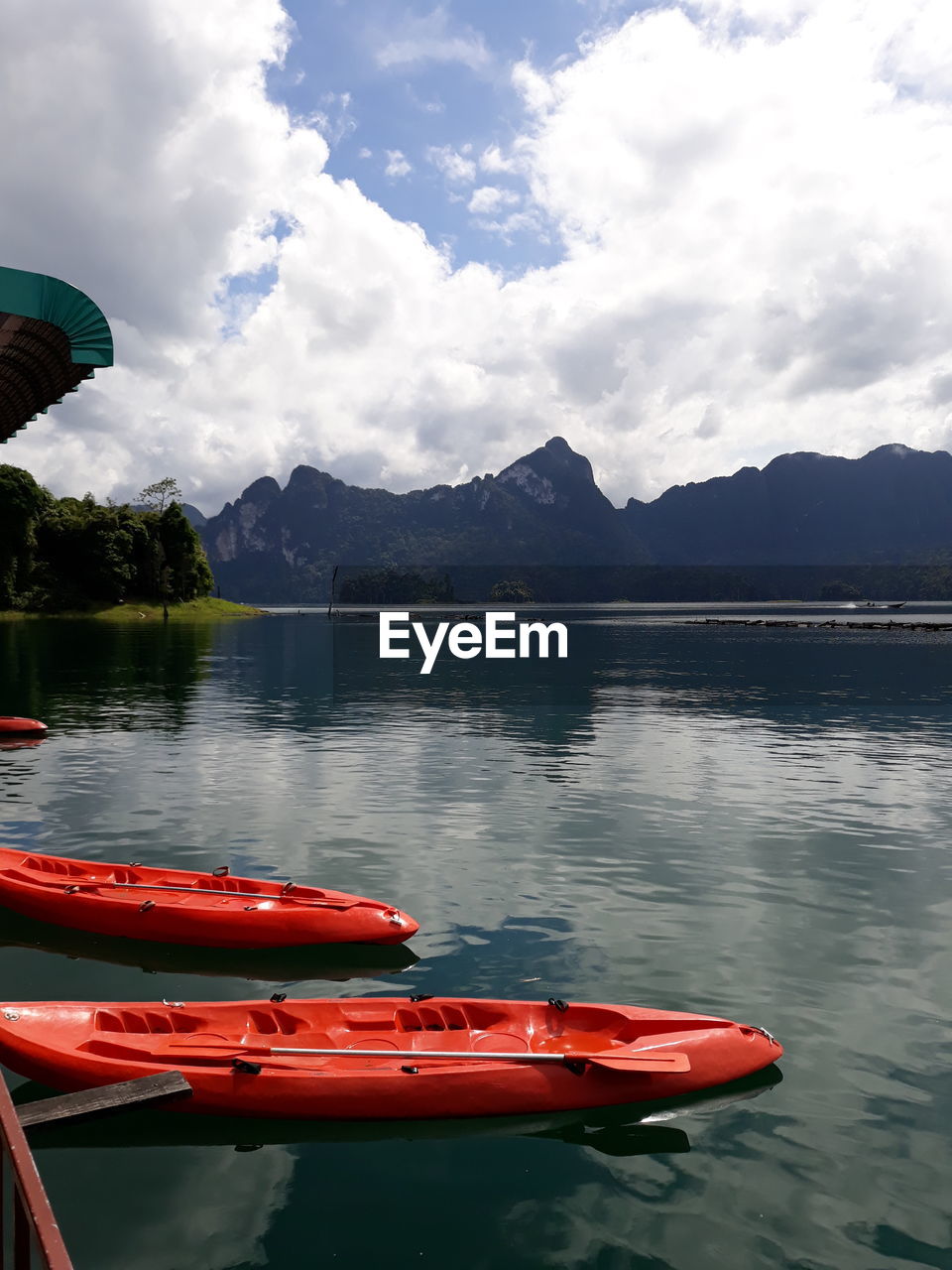 Boat moored in lake against sky