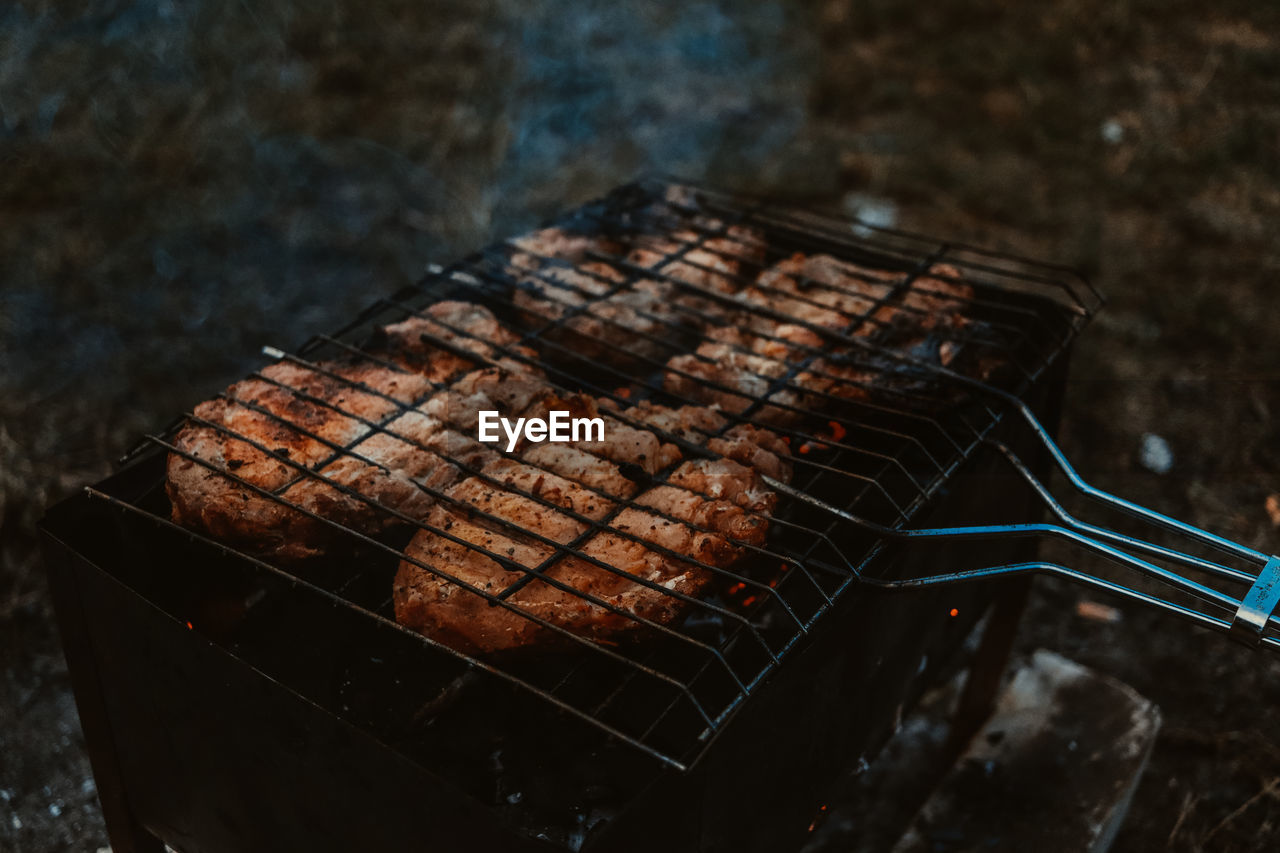 High angle view of meat on barbecue grill