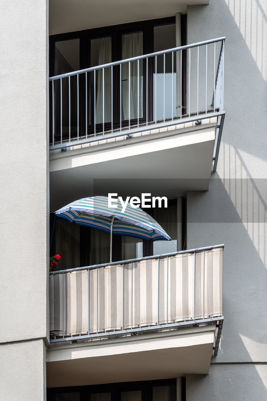 Detail of a umbrella on the balcony of an apartment building in berlin.