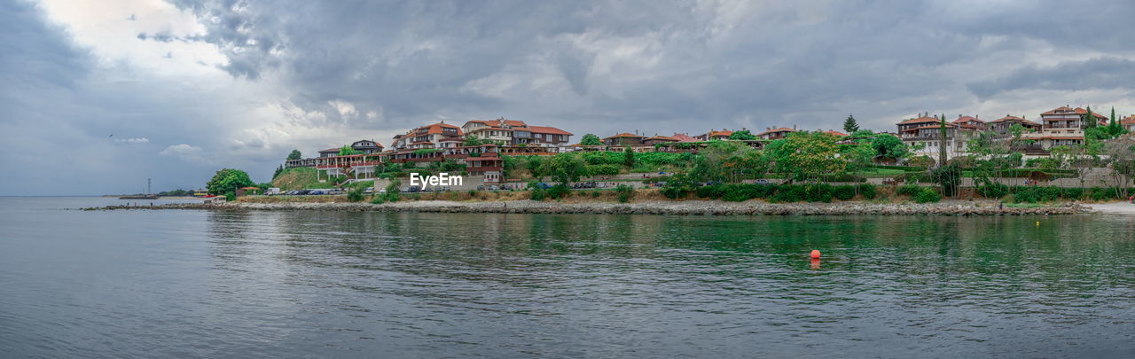 PANORAMIC VIEW OF SEA AGAINST BUILDINGS IN CITY