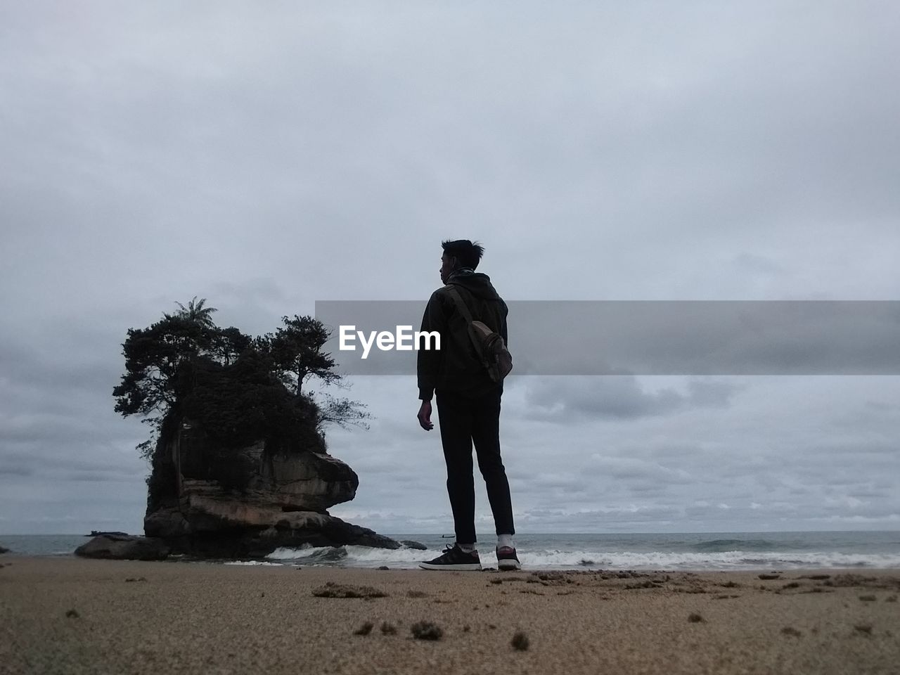 Rear view of man standing on beach