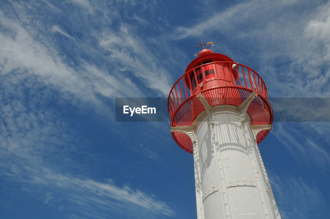 LOW ANGLE VIEW OF RED TOWER ON WATER AGAINST SKY