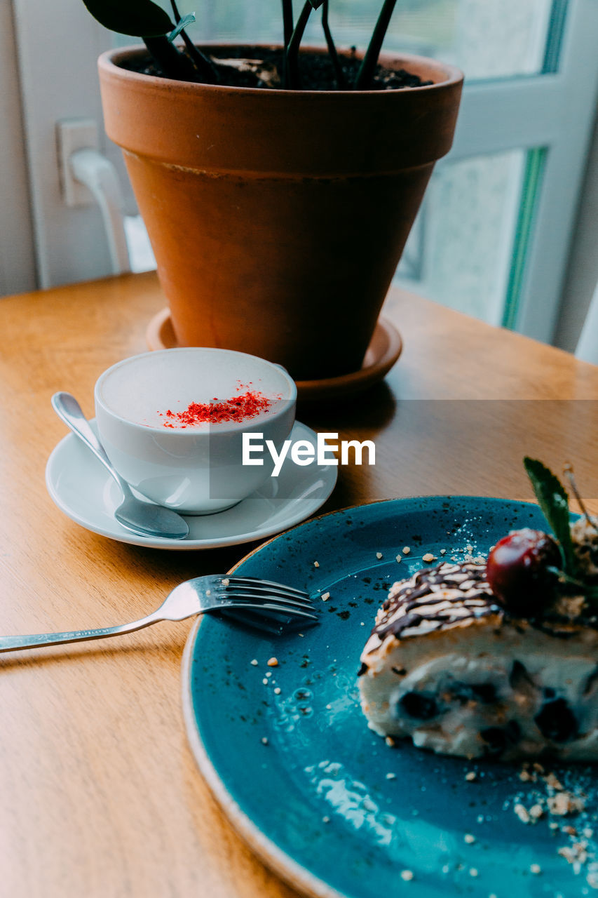 Breakfast by plant on table