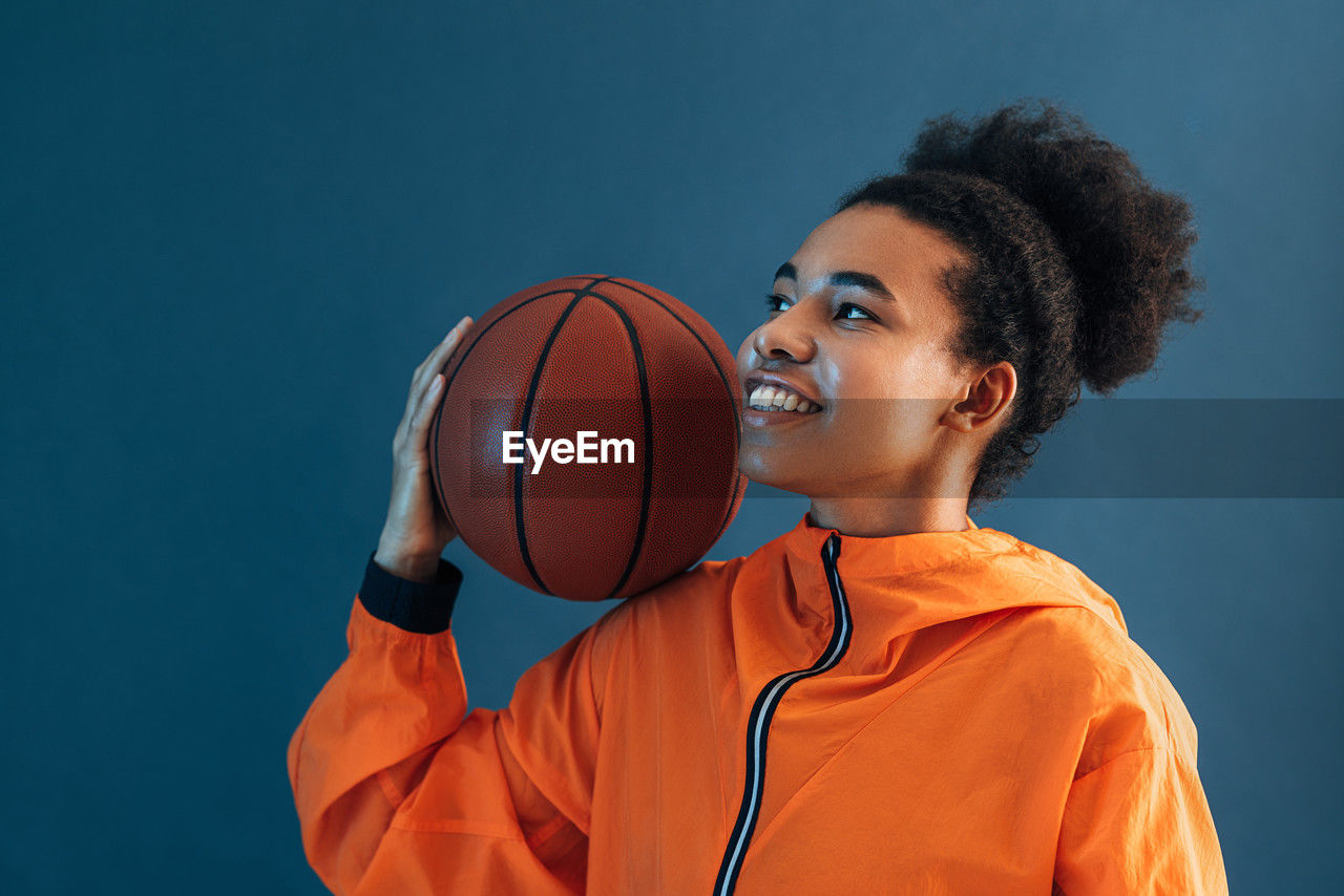 portrait of young man playing basketball