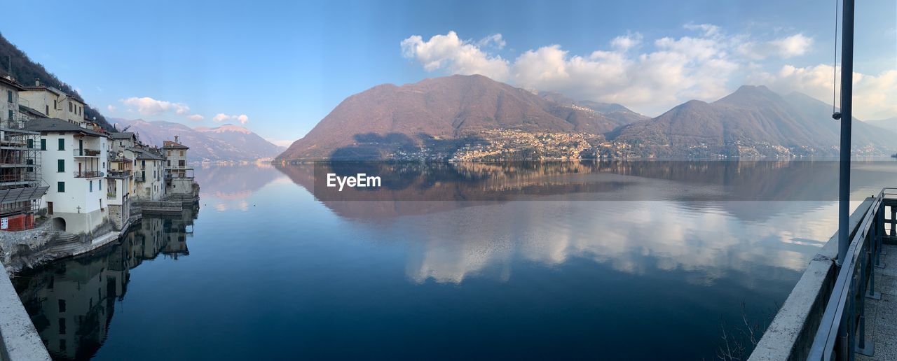 PANORAMIC VIEW OF LAKE BY MOUNTAINS AGAINST SKY