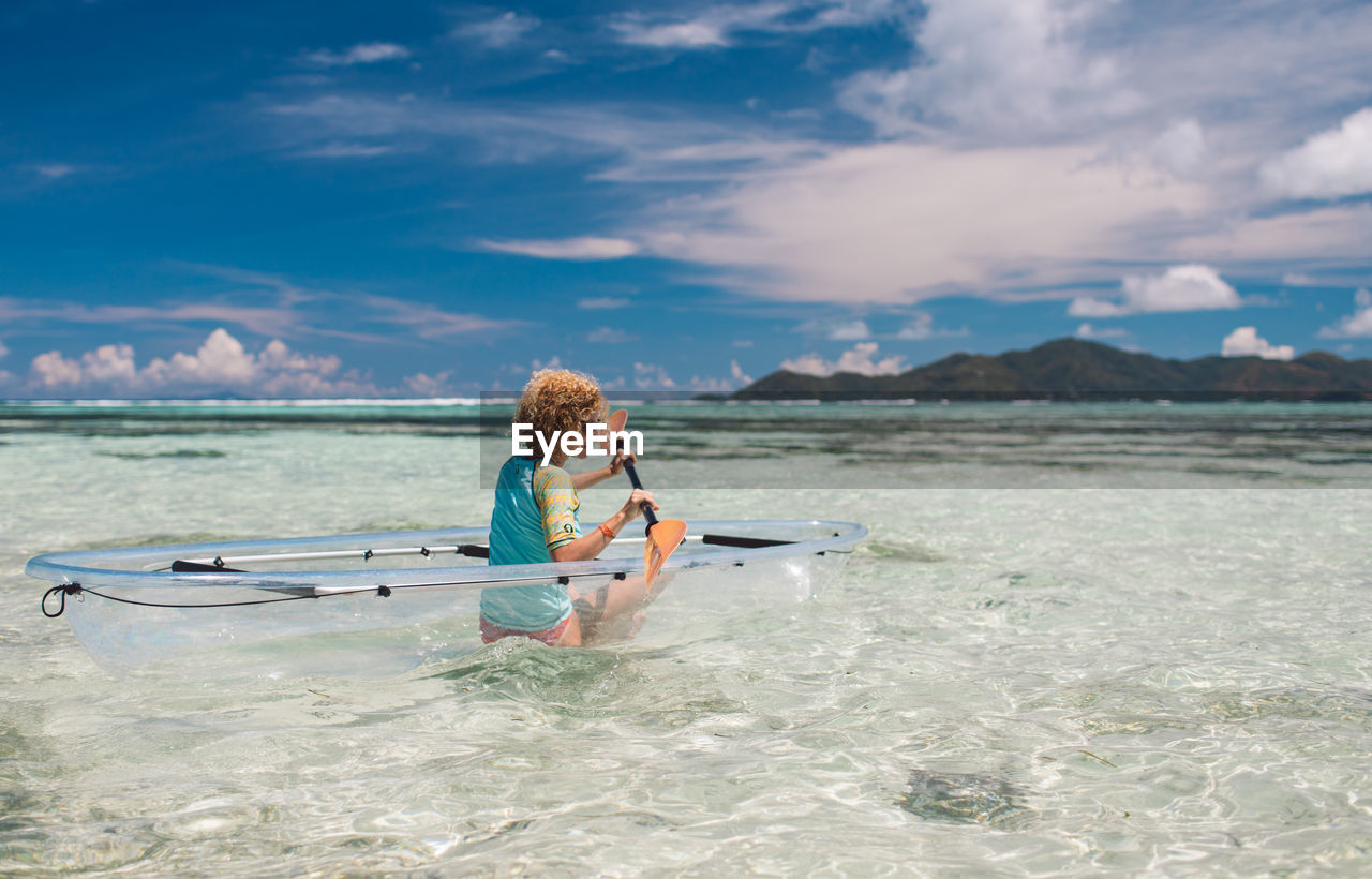 Woman kayaking in water
