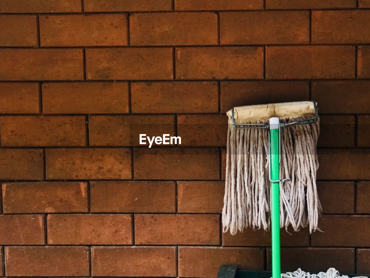 CLOTHES HANGING ON BRICK WALL AGAINST STONE WALLS